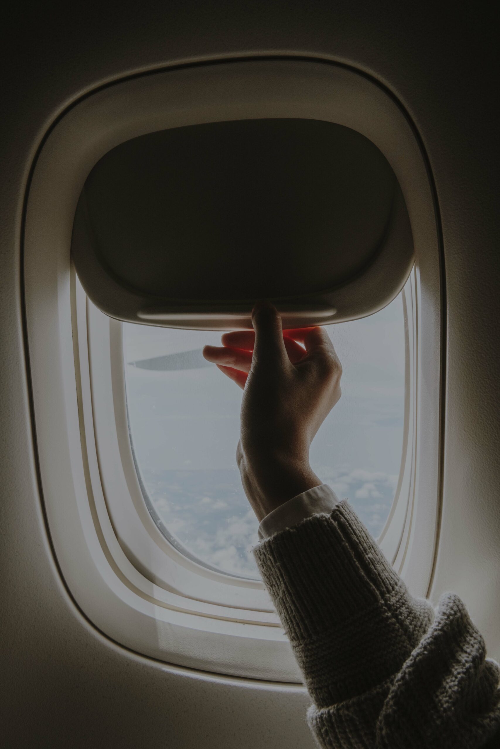 Woman opening a window shade